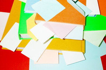 Colorful books on office business work desk and hard direct flashlight