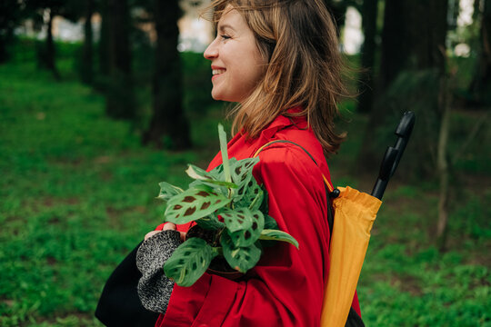 Woman walking with a plant