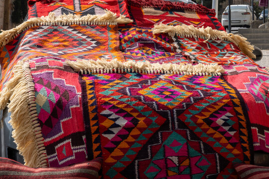 Bright colorful pattened rugs on a car