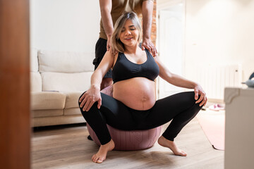 Pregnant woman relaxing with fitness ball.