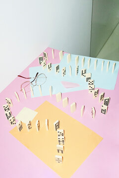 Curvy playful tactic row of dominos in office desk and hard flashlight