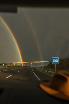 traveling seeing a double rainbow on the road