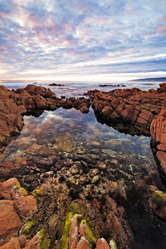 Coastal rock tidal pool at sunset