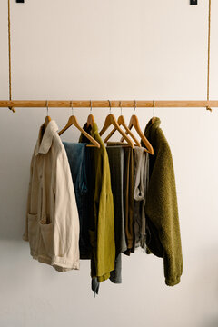 Clean clothes arranged with wooden hooks