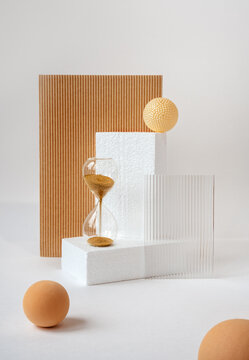 Abstract still life with hourglass and textured geometrical objects