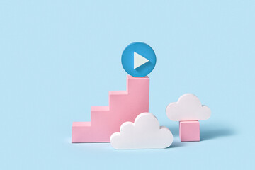 Handcraft paper staircase with blue button play on top among clouds