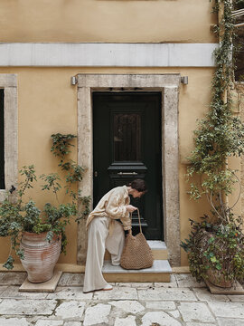 Woman standing near old door.