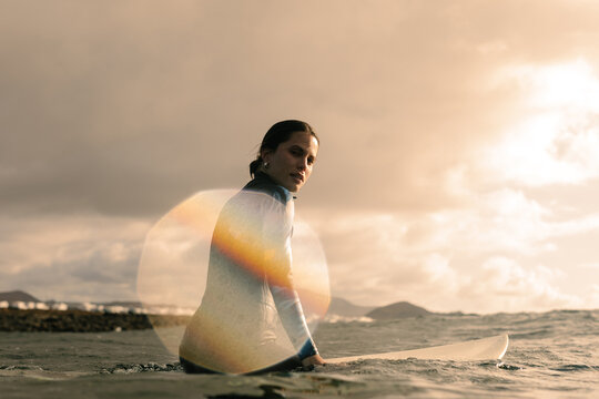A portrait captures the joy of a professional surfer as she floats