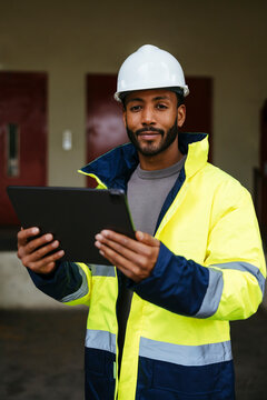 Professional engineer with digital tablet on industrial site