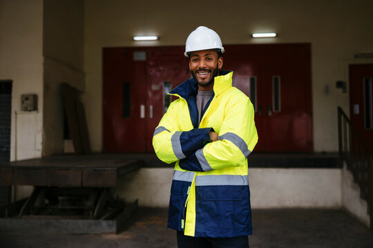 Confident engineer in safety gear at industrial site