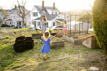family gardening together in yard in spring