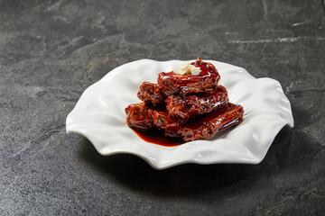 traditional chinese braised mocha coffee wok fried fat meat pork ribs chicken in spicy pepper and sweet sauce in plate on stone table hotel cafe luxury halal food restaurant banquet menu