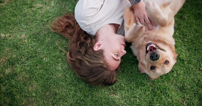 Happy woman, dog and play on grass at park for care, love or friends bonding together in top view outdoor. Animal, girl or pet owner with golden retriever on lawn to relax, smile or tickle game above