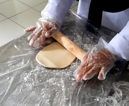 close up of a baker kneading dough