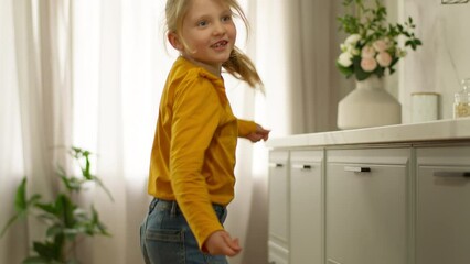 Little happy girl dancing singing daughter child joyful fun kid enjoyment celebrate weekend smile playful excited motion practicing jump energetic expression emotion positive active baby home morning - Powered by Adobe