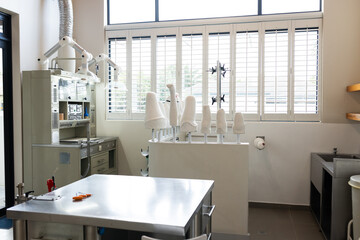 A modern prosthetic lab with various prosthetic limbs displayed on stands