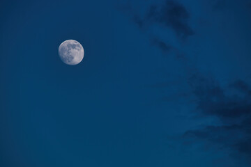 Moon in a blue sky on a spring evening in Potzbach, Germany.