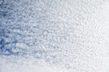 Beautiful blue sky with high Cirrocumulus white clouds, textured nature background
