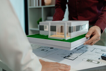 an architect and an engineer are exchange their strategy about model house that the client wanted...