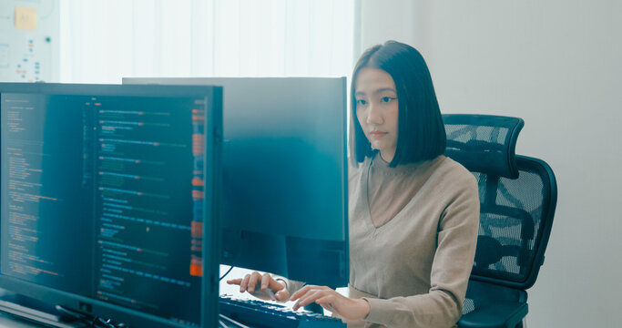Young adult Asia female freelance typing write prompt AI bot IT app smart program nomad, video game, terminal with coding language, user interface, designer, big data center on desktop computer.