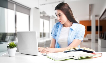 Woman working, checking emails sitting in an office