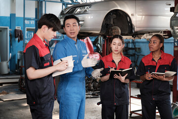 Specialist lecture. Male supervisor engineer describe automotive suspension fixing with mechanic...