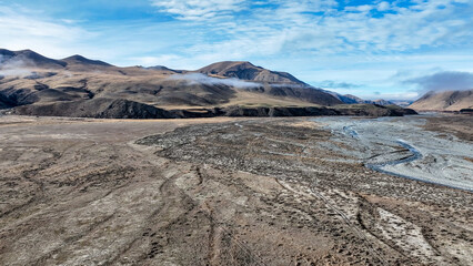 Drone  view of the Ashburton highlands with a river flowing through the dry arid terrain on the way to Lake Heron