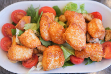 Delicious salad with crispy chicken, cherry tomatoes, and fresh greens a healthy meal