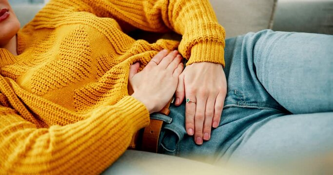 Woman, hands and tummy ache with pain or cramp on sofa in menstruation, constipation or gastro at home. Closeup of female person with diarrhea, abdomen injury or digestion issue from stomach virus