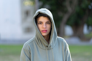Woman with short hair and masculine appearance and serious look wearing a hoodie