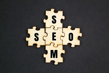horizontal and vertical puzzle with the letters SEM and SEO. Engine Optimization and Search Engine...