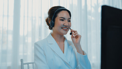 Businesswoman wearing vivancy headset working in office to support remote customer or colleague. Call center, telemarketing, customer support agent provide service on telephone video conference call