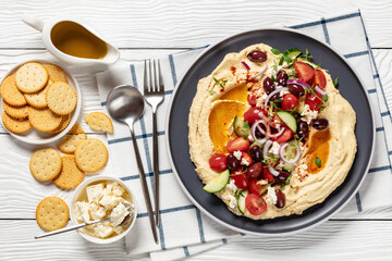 Greek hummus with veggies, olives, feta on plate