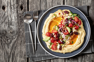 Greek hummus with veggies, olives, feta on plate