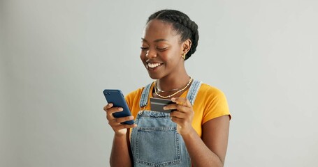 African woman, credit card and smartphone in studio with smile for deal, discount or fintech by...