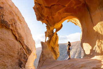 Adventurer Ponders Arco De Las Penitas in Afternoon Light, Fuerteventura