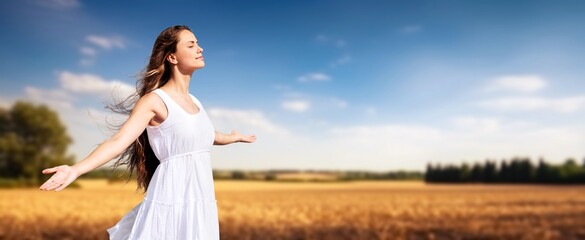 Young happy woman outstretched arms on big field © BillionPhotos.com