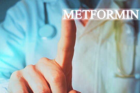 Close up of a doctor pointing finger up at the word "Metformin" in background. Medicine used in standard oral therapy of type 2 diabetes in people who are overweight High Blood Sugar Treatment