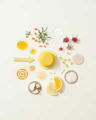 Round yellow solid shampoo with natural ingredients. Soap with citrus. Circular composition of dry shampoo ingredients. Hair care products. Advertising. White background. Copy space.