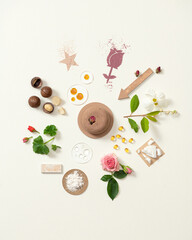 Round pink solid shampoo with natural ingredients. Soap with flowers. Circular composition of dry shampoo ingredients. Hair care products. Advertising. White background. Copy space.