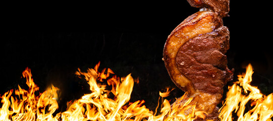 Brazilian style beef ribs Barbecue grill on skewers  at a churrascaria steakhouse in Brazil.