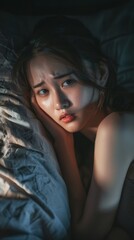 Naklejka premium Asian young woman struggling to sleep at night