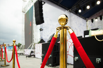 Golden stanchions with a red rope.  private event  concept