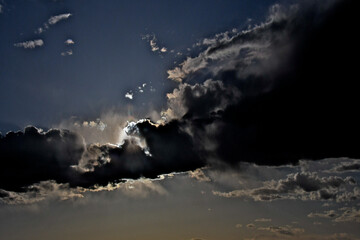 The sun breaking through storm clouds is a metaphor for the idiom “every cloud has a silver...