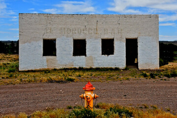 Colorful fire hydrant and black and white building. Diego Tafoya built the El Morocco Bar In the...