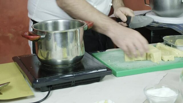 Italian chef cuts Panella Sicilian fritters made of chickpea flour kitchen hands closeup shot