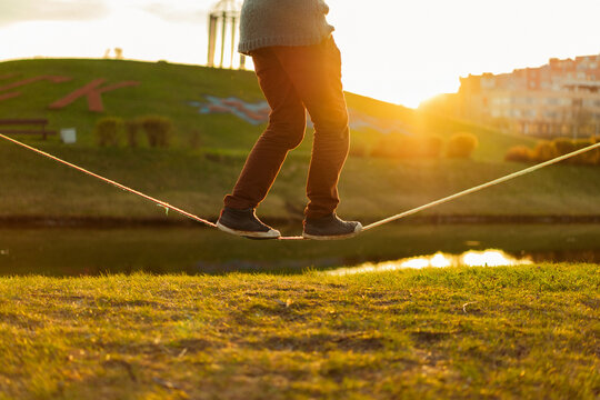 Young man balancing on slackline.