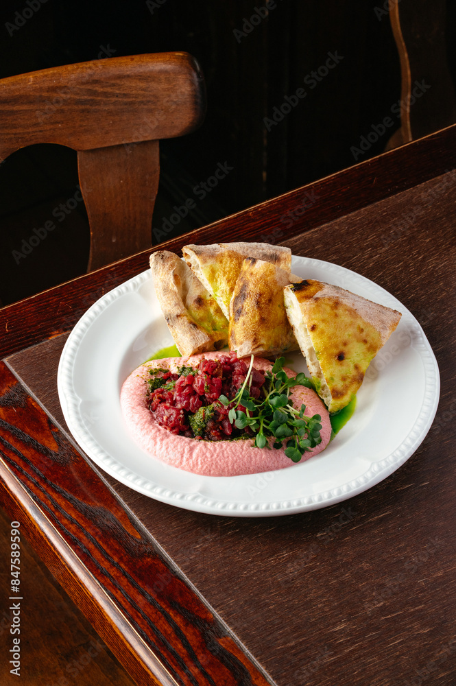 Poster marbled beef carpaccio with mousse and chabata on a plate