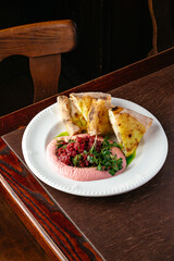 marbled beef carpaccio with mousse and chabata on a plate