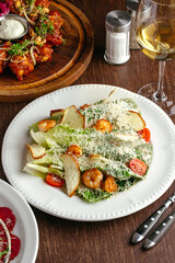 Caesar salad with shrimp and sauce. restaurant menu